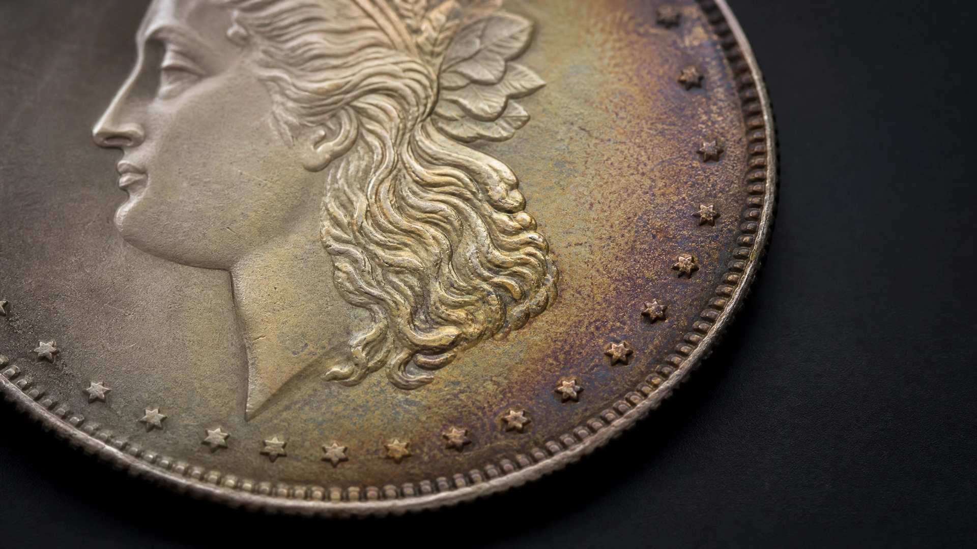 Silver coin showing natural gray, gold, and blue-purple environmental toning